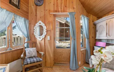 a wooden room with a door and a chair at Gorgeous Home In Øyer With Sauna in Øyer
