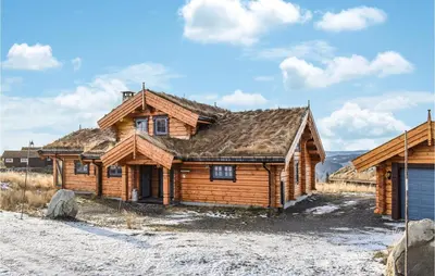 a log cabin in the middle of a field at Beautiful Home In Øyer With Sauna in Øyer