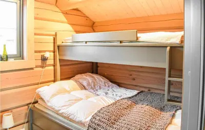 a room with a bunk bed in a cabin at Beautiful Home In Øyer With Sauna in Øyer