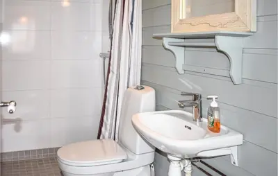 a bathroom with a toilet and a sink at Amazing Home In Øyer With Kitchen in Øyer
