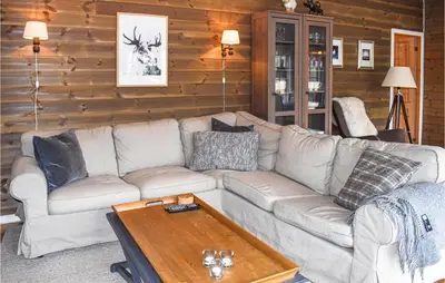 a living room with a couch and a coffee table at Amazing Home In Øyer With Kitchen in Øyer