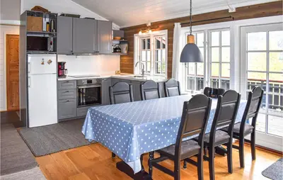 a kitchen and dining room with a table and chairs at Amazing Home In Øyer With Kitchen in Øyer