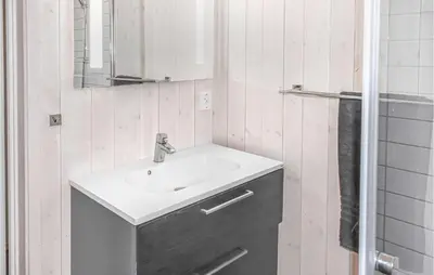 a bathroom with a sink and a mirror at Beautiful Home In Øyer With Sauna in Øyer