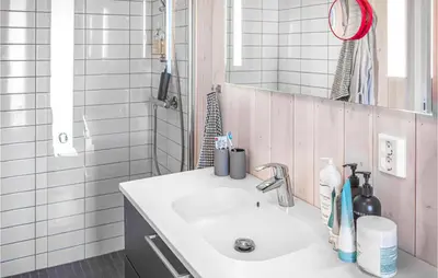 a bathroom with a white sink and a mirror at Beautiful Home In Øyer With Sauna in Øyer