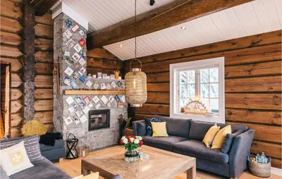 a living room with a couch and a fireplace at Solbergsætra in Øyer