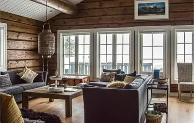 a living room with a couch and a table at Solbergsætra in Øyer