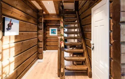 a staircase in a log cabin with wooden walls at Solbergsætra in Øyer