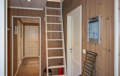 a room with wooden walls and a room with shelves at Stunning Home In Øyer With Wifi in Øyer
