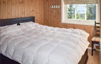 a large white bed in a room with a window at Stunning Home In Øyer With Wifi in Øyer