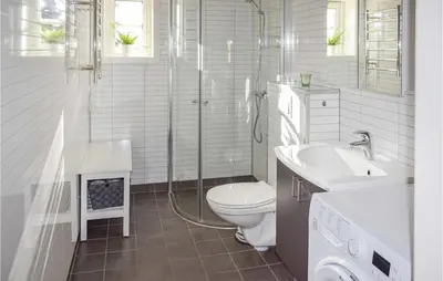 a white bathroom with a toilet and a sink at Stunning Home In Øyer With Wifi in Øyer