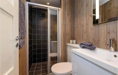 a bathroom with a toilet and a sink and a shower at Gorgeous Home In Sjusjøen With Kitchen in Sjusjøen