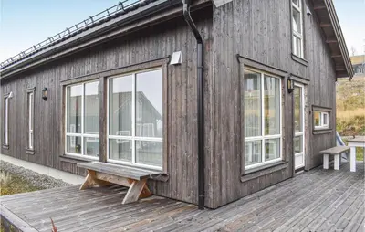 a wooden building with a bench on a deck at 4 Bedroom Stunning Home In Øyer in Øyer