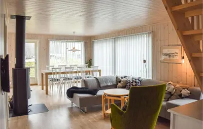 a living room with a couch and a table at 4 Bedroom Stunning Home In Øyer in Øyer