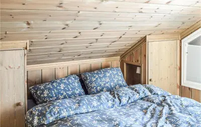 a bed in the corner of a tiny house at Amazing Home In Mesnali With Wifi in Mesnali