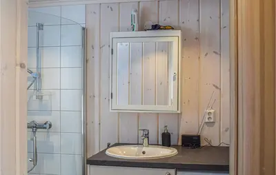 a bathroom with a sink and a cabinet and a shower at Amazing Home In Mesnali With Wifi in Mesnali