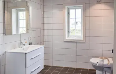 a white bathroom with a sink and a toilet at 3 Bedroom Amazing Home In Sjusjøen in Sjusjøen