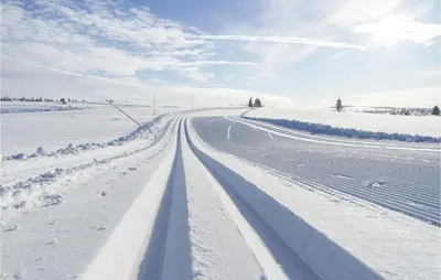a road covered in snow in a field at Nice Home In Sjusjøen With Kitchen in Sjusjøen