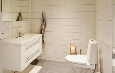 a white bathroom with a toilet and a sink at Nice Home In Sjusjøen With Kitchen in Sjusjøen