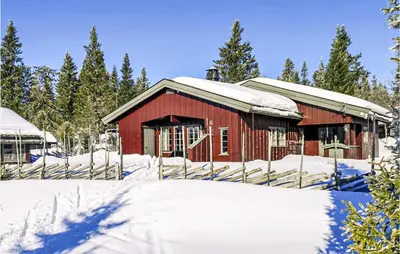 a red barn with snow on it in the snow at Sjusjøen Pihl 4001 in Sjusjøen