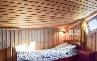 a room with a bed in a wooden room at Sjusjøen Pihl 4001 in Sjusjøen