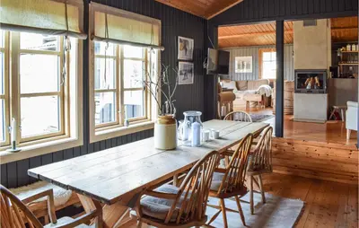 a wooden table and chairs in a living room at Nice Home In Sjusjøen With Wifi in Sjusjøen