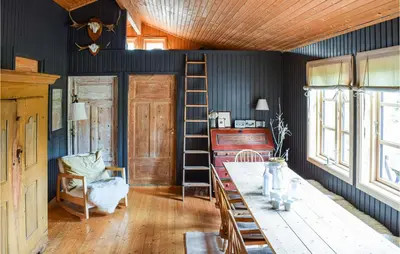a room with blue walls and a ladder and a desk at Nice Home In Sjusjøen With Wifi in Sjusjøen