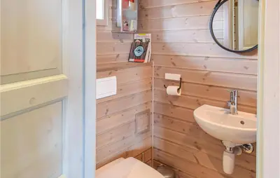 a bathroom with a toilet and a sink at 4 Bedroom Beautiful Home In Sjusjøen in Sjusjøen