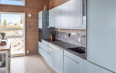 a kitchen with white cabinets and a sink at 4 Bedroom Beautiful Home In Sjusjøen in Sjusjøen