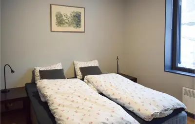 two beds sitting next to each other in a bedroom at Leil 70 in Sjusjøen