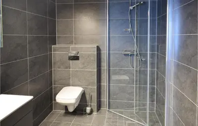a bathroom with a shower with a toilet and a sink at Leil 70 in Sjusjøen