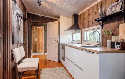 a kitchen with wooden walls and a white counter top at 4 Bedroom Gorgeous Home In Sjusjøen in Sjusjøen