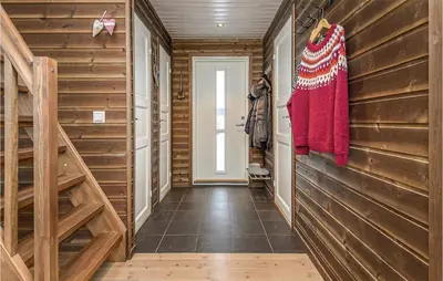 a hallway in a log cabin with wooden walls at 4 Bedroom Amazing Home In Lillehammer in Lillehammer