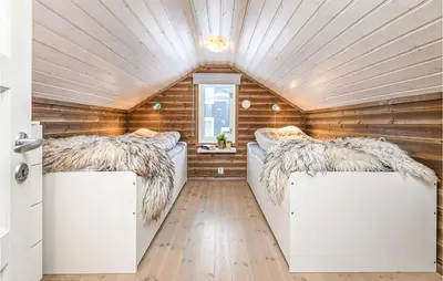 a room with two beds in a tiny house at 4 Bedroom Amazing Home In Lillehammer in Lillehammer