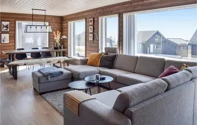 a living room with a couch and a piano at 4 Bedroom Cozy Home In Sjusjøen in Sjusjøen