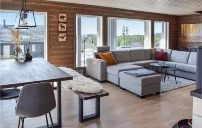 a living room with a couch and a table at 4 Bedroom Cozy Home In Sjusjøen in Sjusjøen