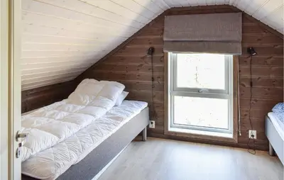 a bed in a room with a window at 4 Bedroom Cozy Home In Sjusjøen in Sjusjøen