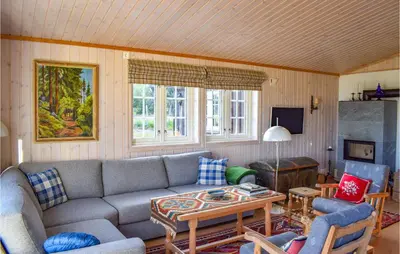 a living room with a couch and a table at Stunning Home In Etnedal With Kitchen in Etnedal