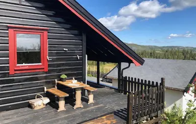 a picnic table on the deck of a cabin at Nice Home In Reinli With Kitchen in Reinli