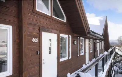 a wooden house with a white door and windows at 2 Bedroom Cozy Apartment In Geilo in Geilo
