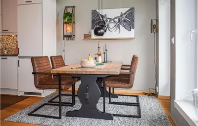 a dining room table with chairs and a candle on it at 2 Bedroom Cozy Apartment In Geilo in Geilo