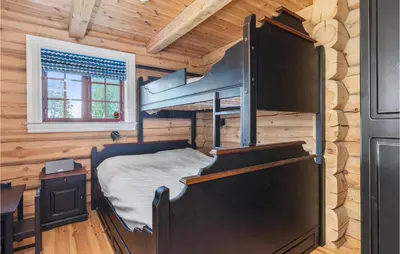 a bedroom with a bunk bed in a log cabin at Gorgeous Home In Lampeland With Kitchen in Lampeland