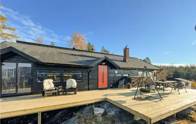 two sheep sitting on benches on the deck of a house at 3 Bedroom Awesome Home In Eggedal in Eggedal