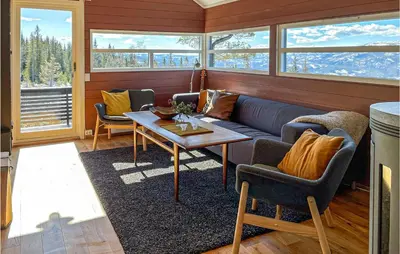 a living room with a couch and a table at 3 Bedroom Awesome Home In Eggedal in Eggedal