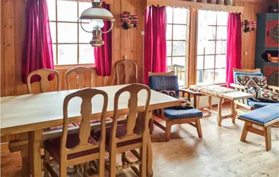 a dining room with a wooden table and chairs at Stunning Home In Uvdal With Wifi in Uvdal