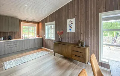 a living room with wooden walls and a wooden desk at Beautiful Home In Rødberg in Rødberg