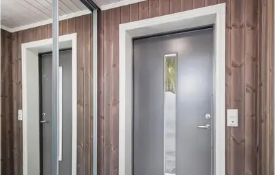 a glass door in a room with wood walls at Beautiful Home In Rødberg in Rødberg