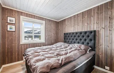 a bedroom with a large bed with a window at Beautiful Home In Rødberg in Rødberg