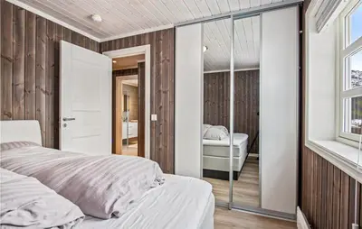 a bedroom with a white bed and a mirror at Beautiful Home In Rødberg in Rødberg