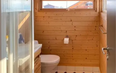 a bathroom with a toilet and a window at 1 Bedroom Nice Home In Geilo in Geilo