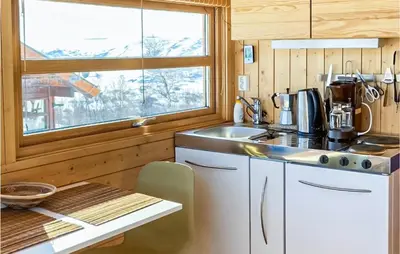 a kitchen with a counter and a sink and a window at 1 Bedroom Nice Home In Geilo in Geilo